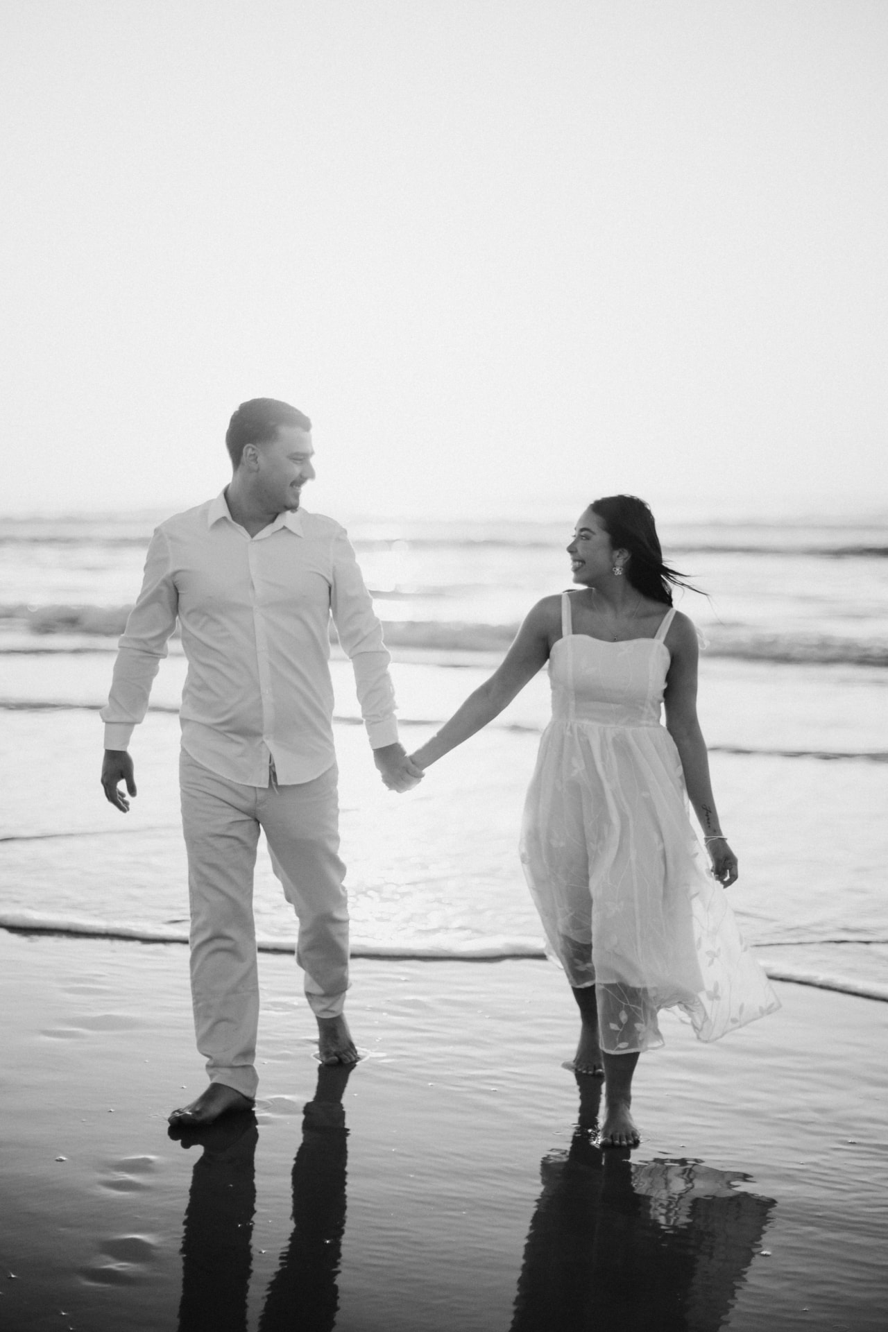 Danielle e Sérgio caminhando juntos à beira-mar